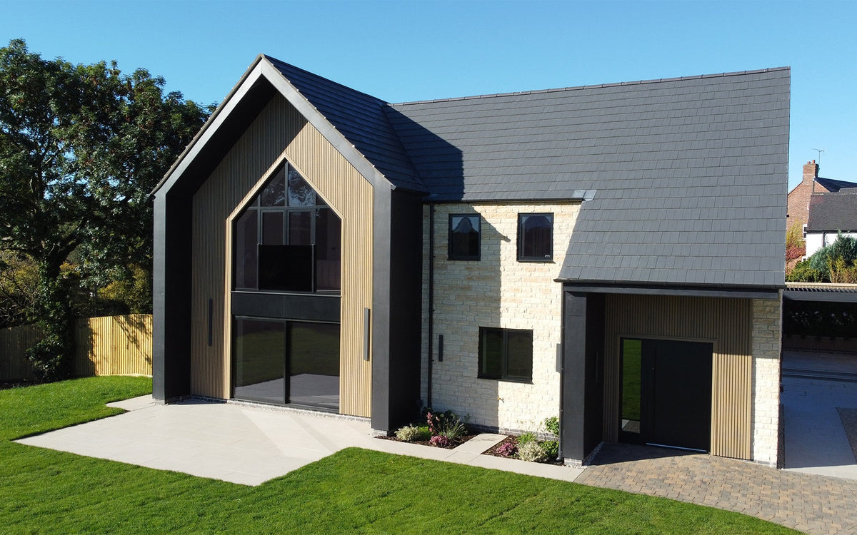 Boxton Homes detached house with Oak slatted composite cladding, brickwork and large apex windows