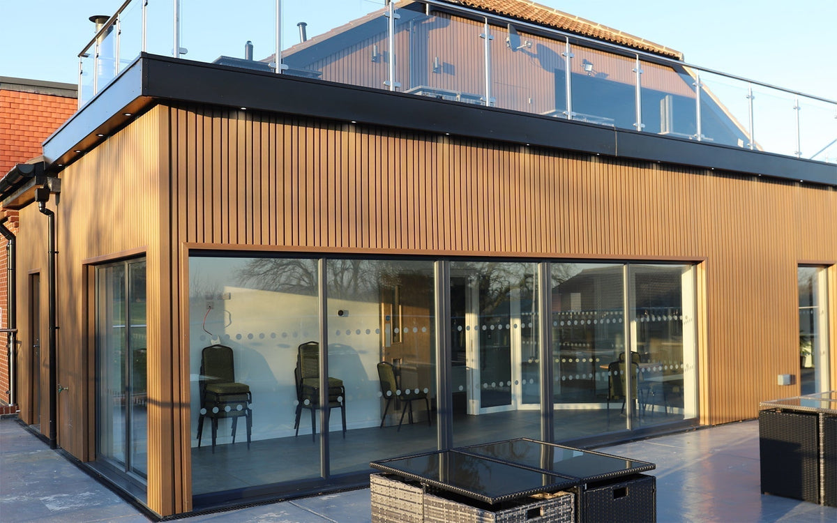 Vertical NeoTimber Teak Board & Batten composite cladding on the Birstall Golf Club clubhouse