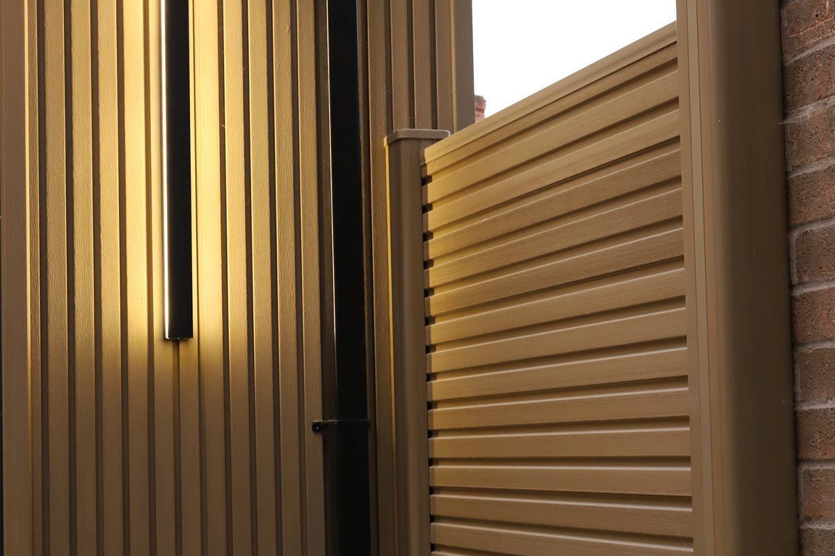 close-up of a neotimber composite fence panel with matching horizontal slats on a building exterior