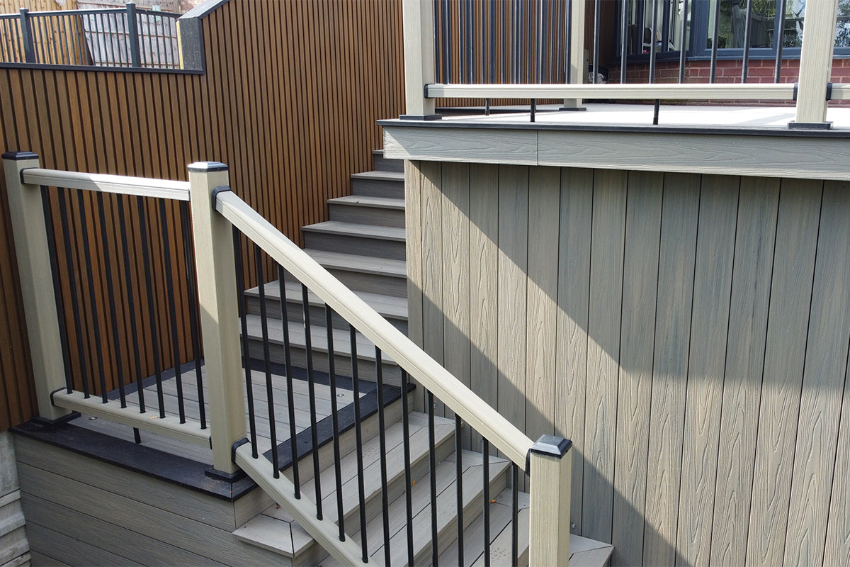 outdoor balustrade staircase with metal and composite railings on a matching composite deck
