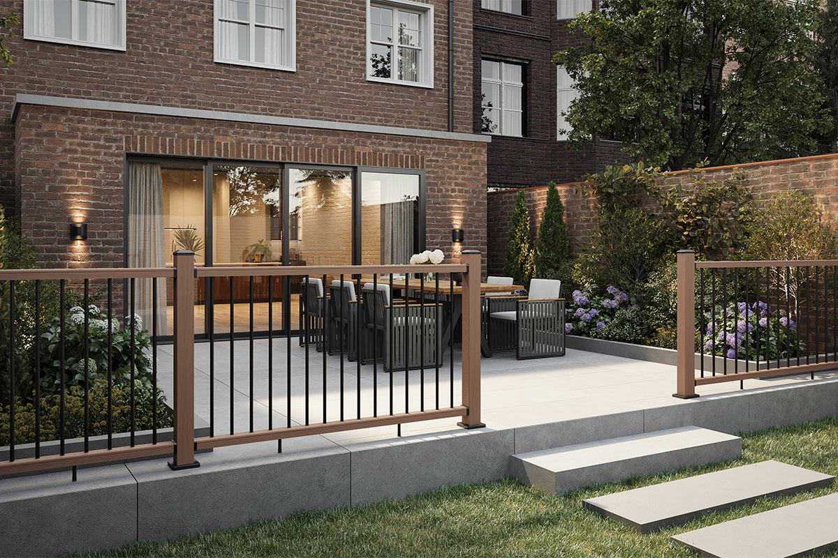 modern outdoor patio area with a composite balustrade rail, glass doors, and a small garden