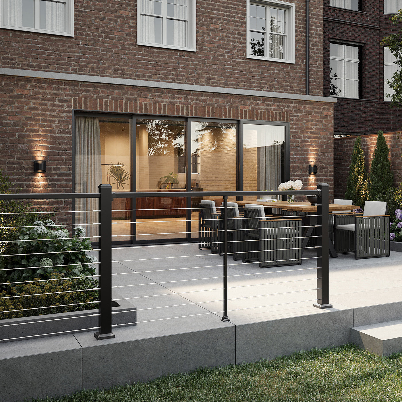 modern outdoor patio with wire railings and furniture in front of a brick building
