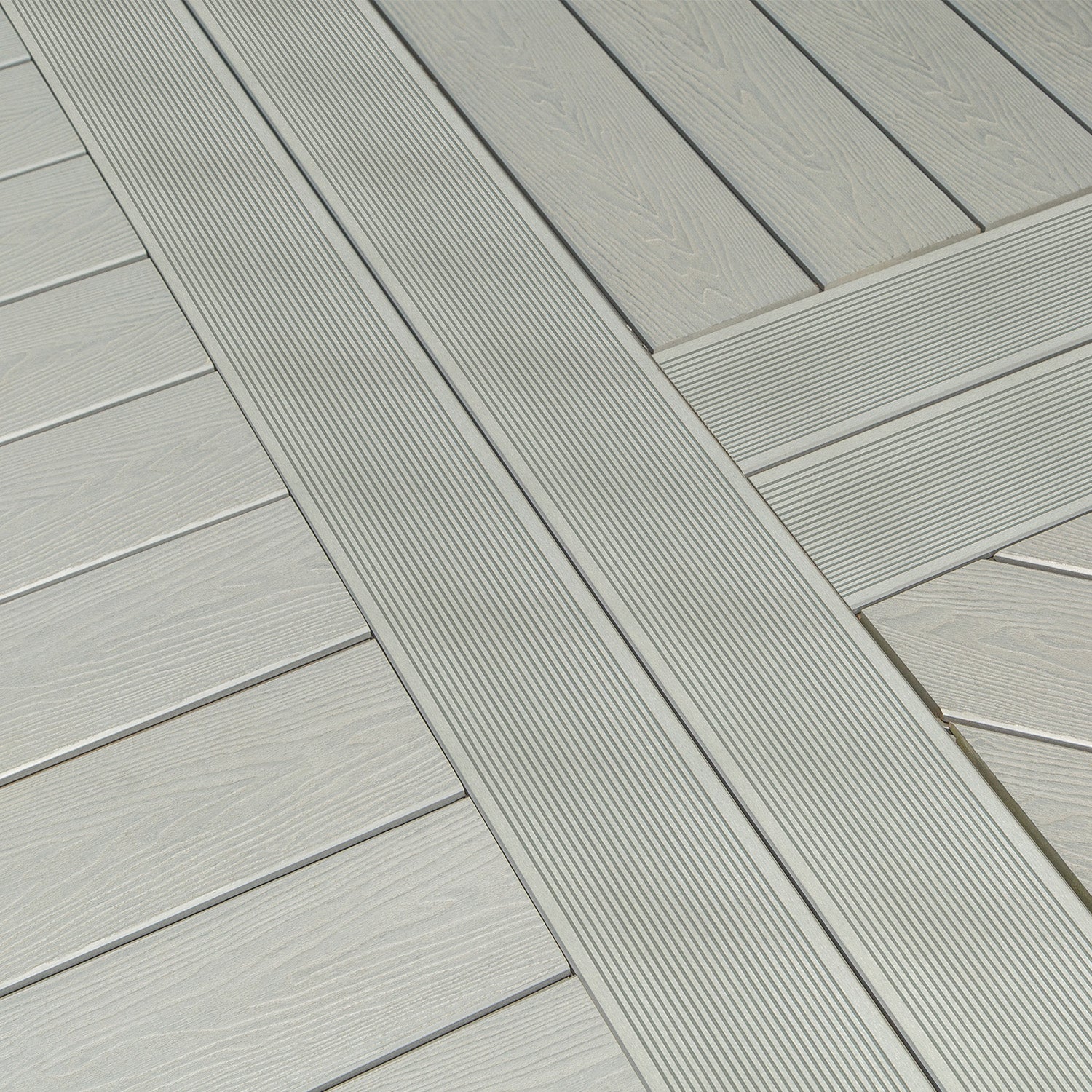 close-up of grey composite deck boards with a herringbone pattern