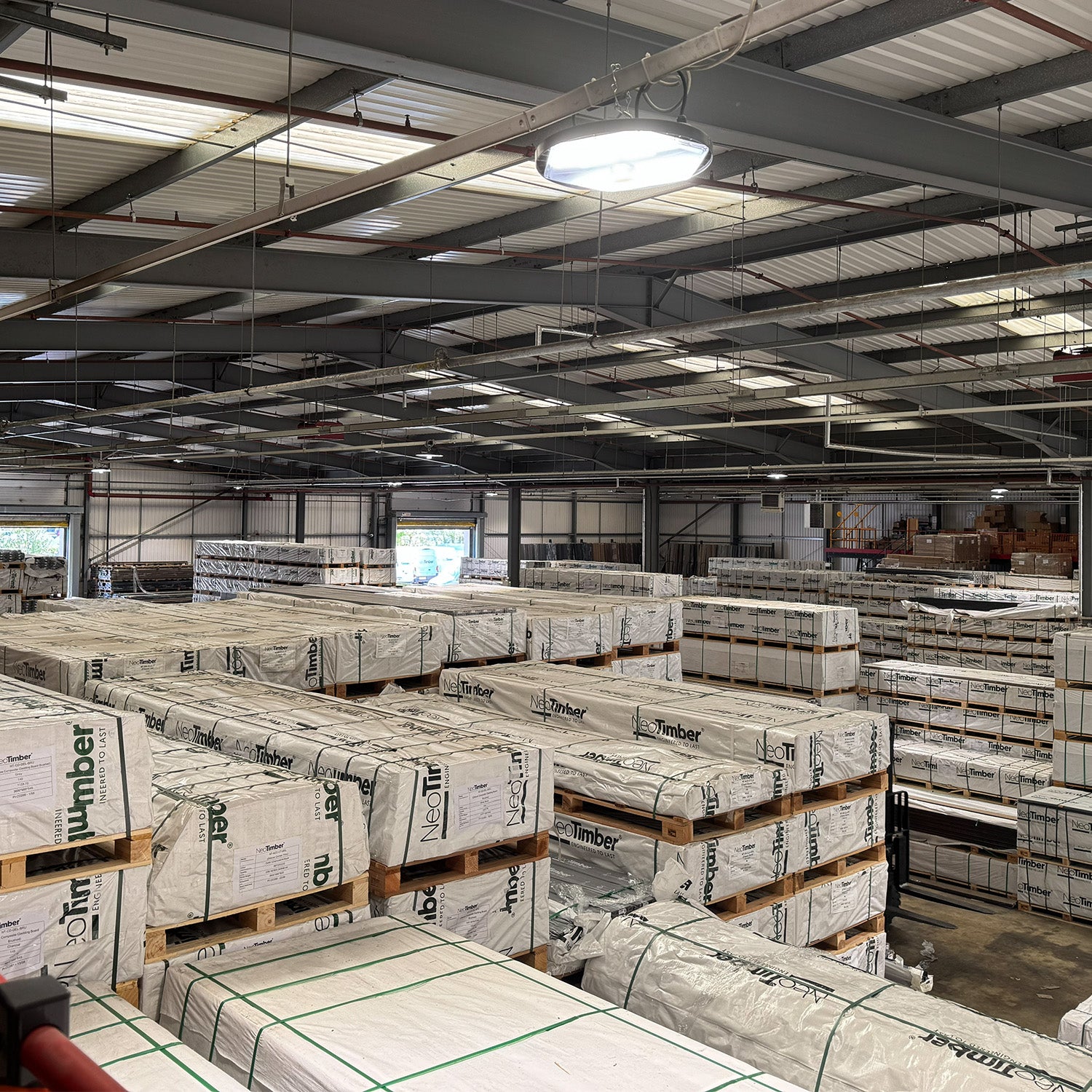large neotimber warehouse with stacked pallets of building materials