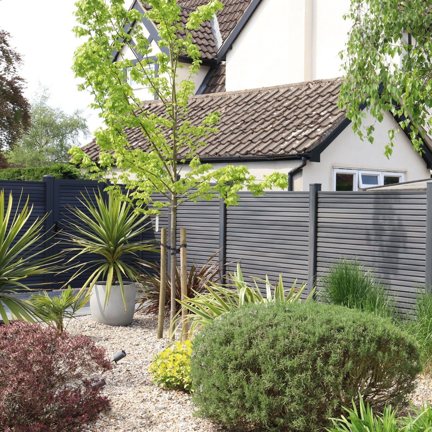 NeoTimber® Slatted Fence Panel Set – Grey Installed in a Modern Garden