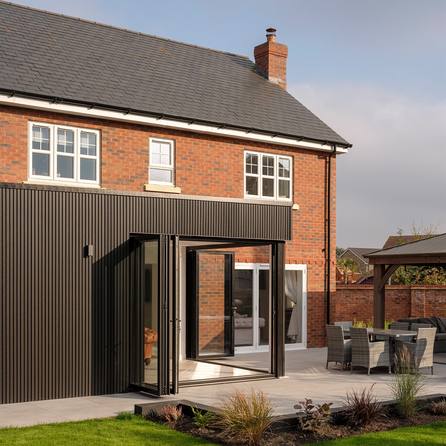 modern home featuring composite cladding and a glass door opening onto an outdoor patio area