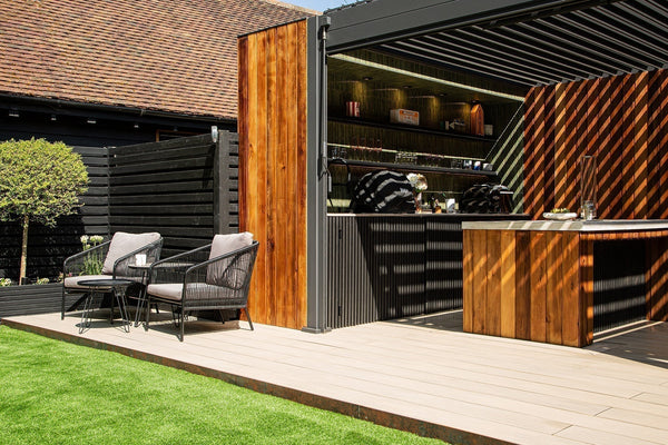 Ash White composite decking surrounding a hot tub with Charcoal slatted cladding in a Much Hadham garden