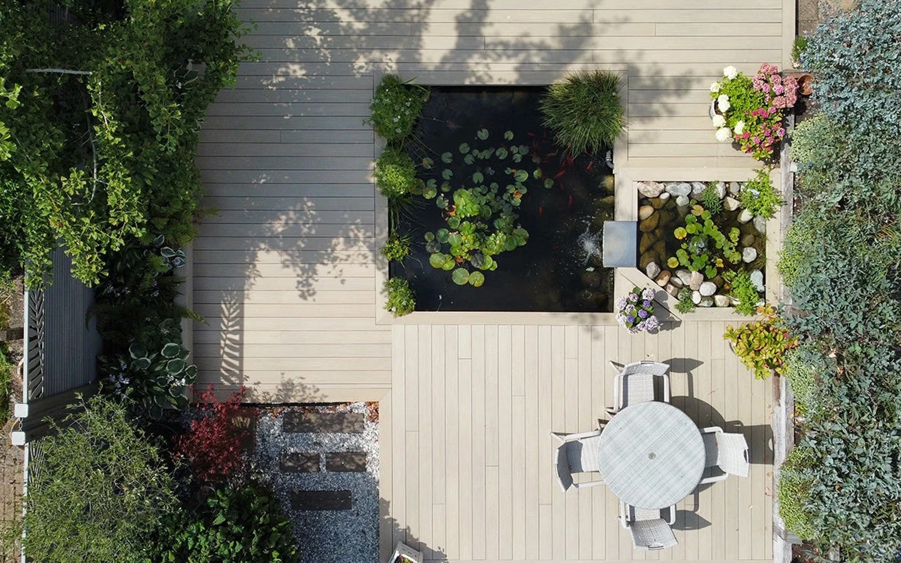 Ash White Decking & Antique Fencing Transform A Pondside Garden