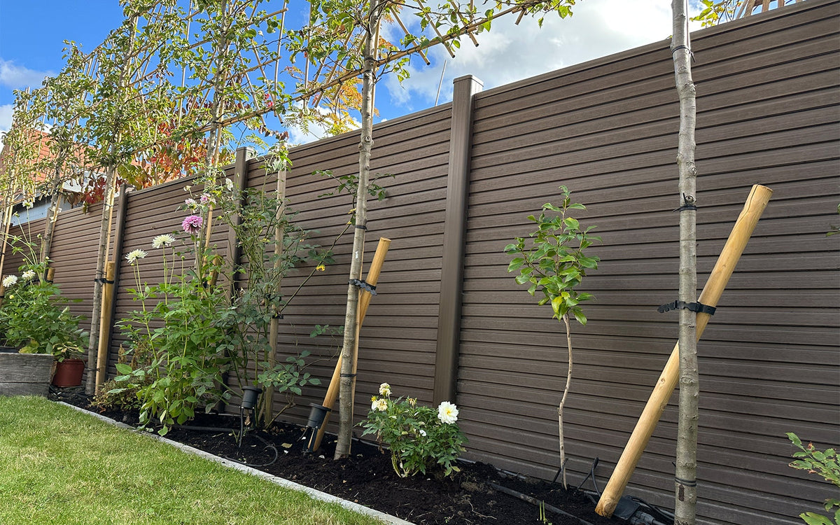chocolate slatted composite fencing framing a landscaped garden in leicestershire