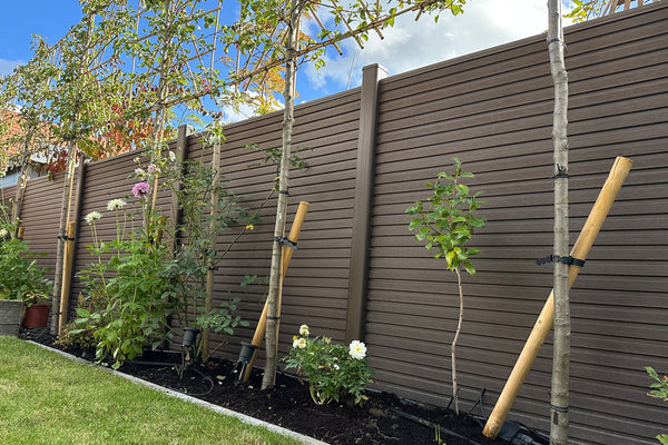 chocolate slatted composite fencing framing a landscaped garden in leicestershire