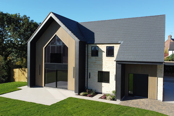 Boxton Homes detached house with Oak slatted composite cladding, brickwork and large apex windows