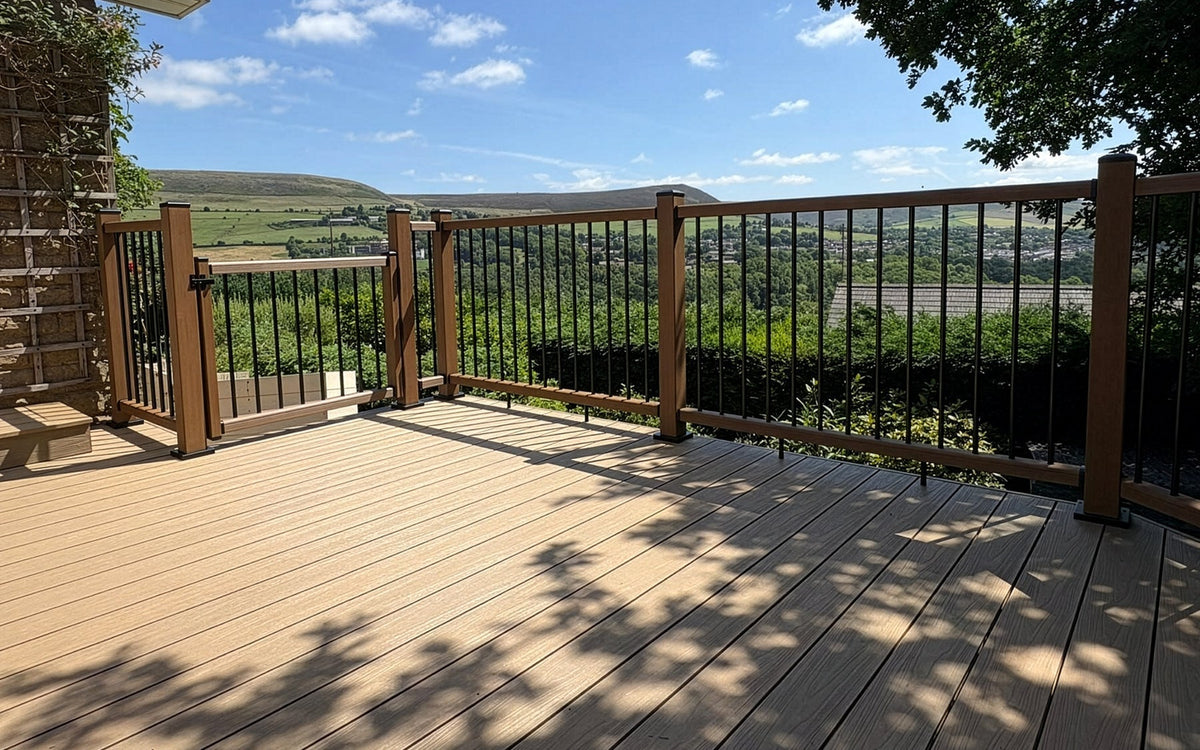 Oak composite decking with Teak balustrades on an elevated balcony overlooking the surrounding landscape