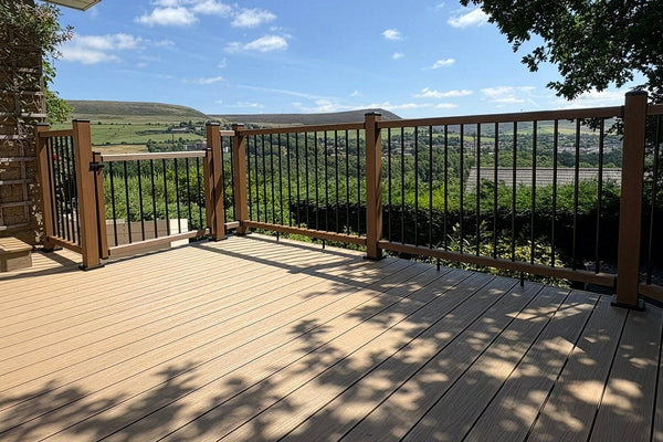 Oak composite decking with Teak balustrades on an elevated balcony overlooking the surrounding landscape