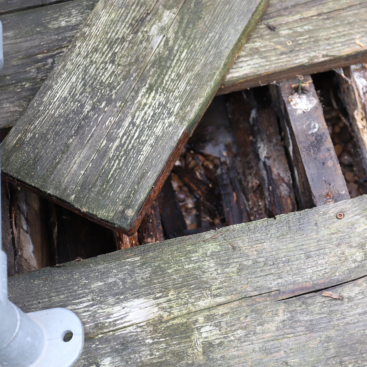 Rotten Wooden Decking Showing Weathered, Damaged and Decaying Timber Boards