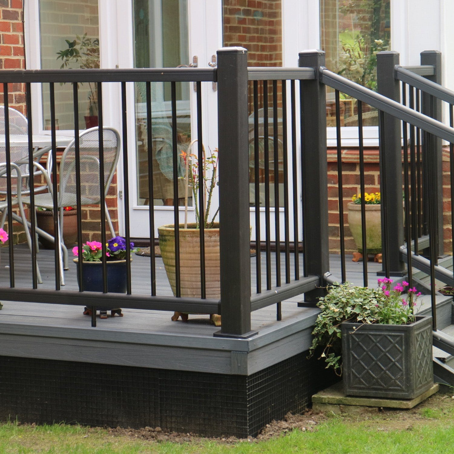 NeoTimber® Charcoal Composite Railing with Grey Decking Boards in Residential Garden