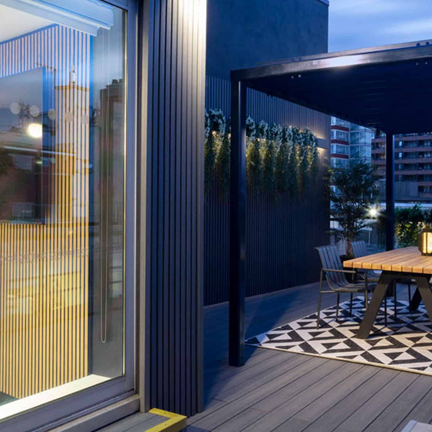 modern outdoor composite deck patio with a table, chairs, and city skyline view