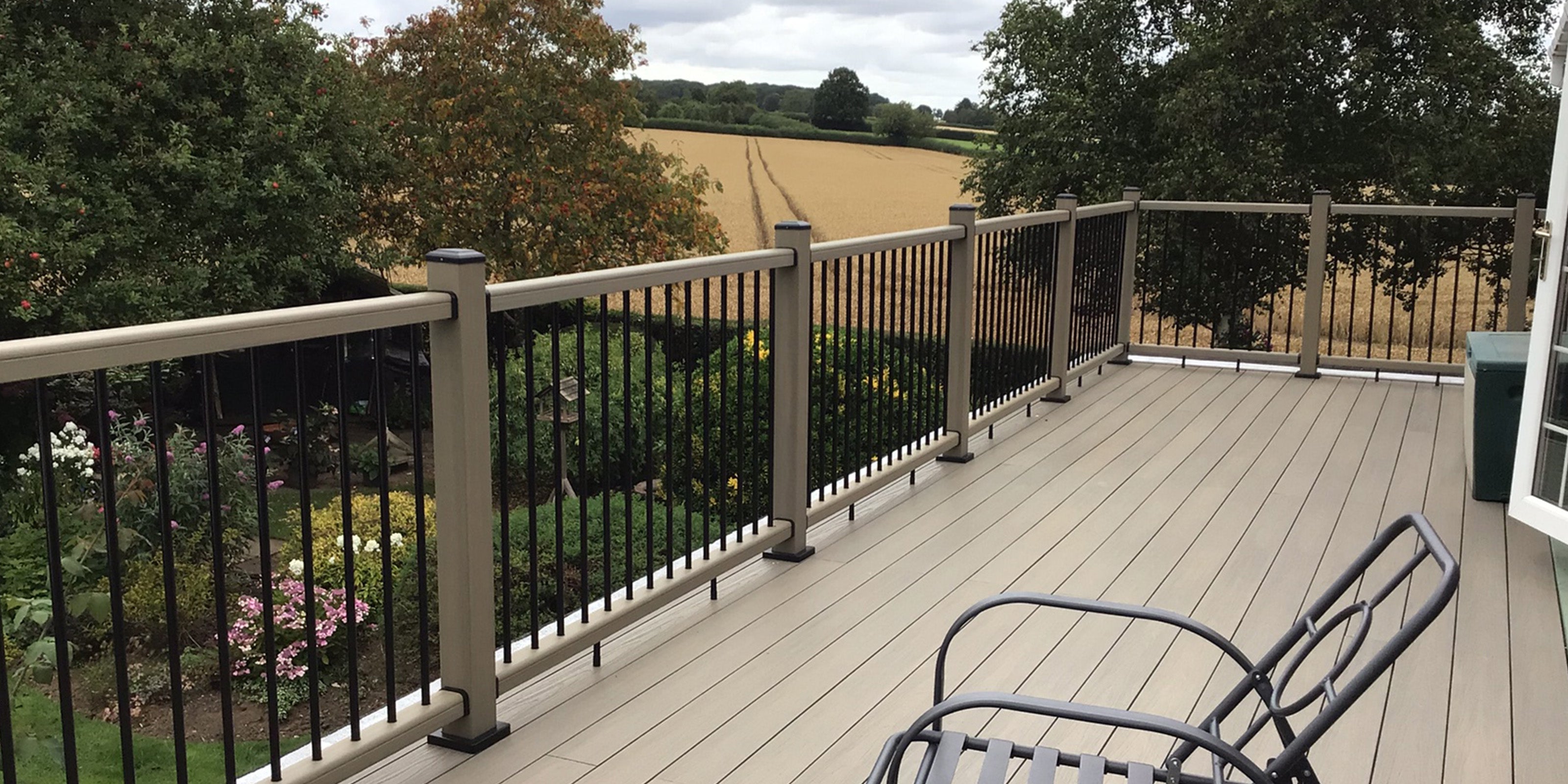 Modern balcony featuring antique composite decking and balustrades overlooking rural countryside scenery