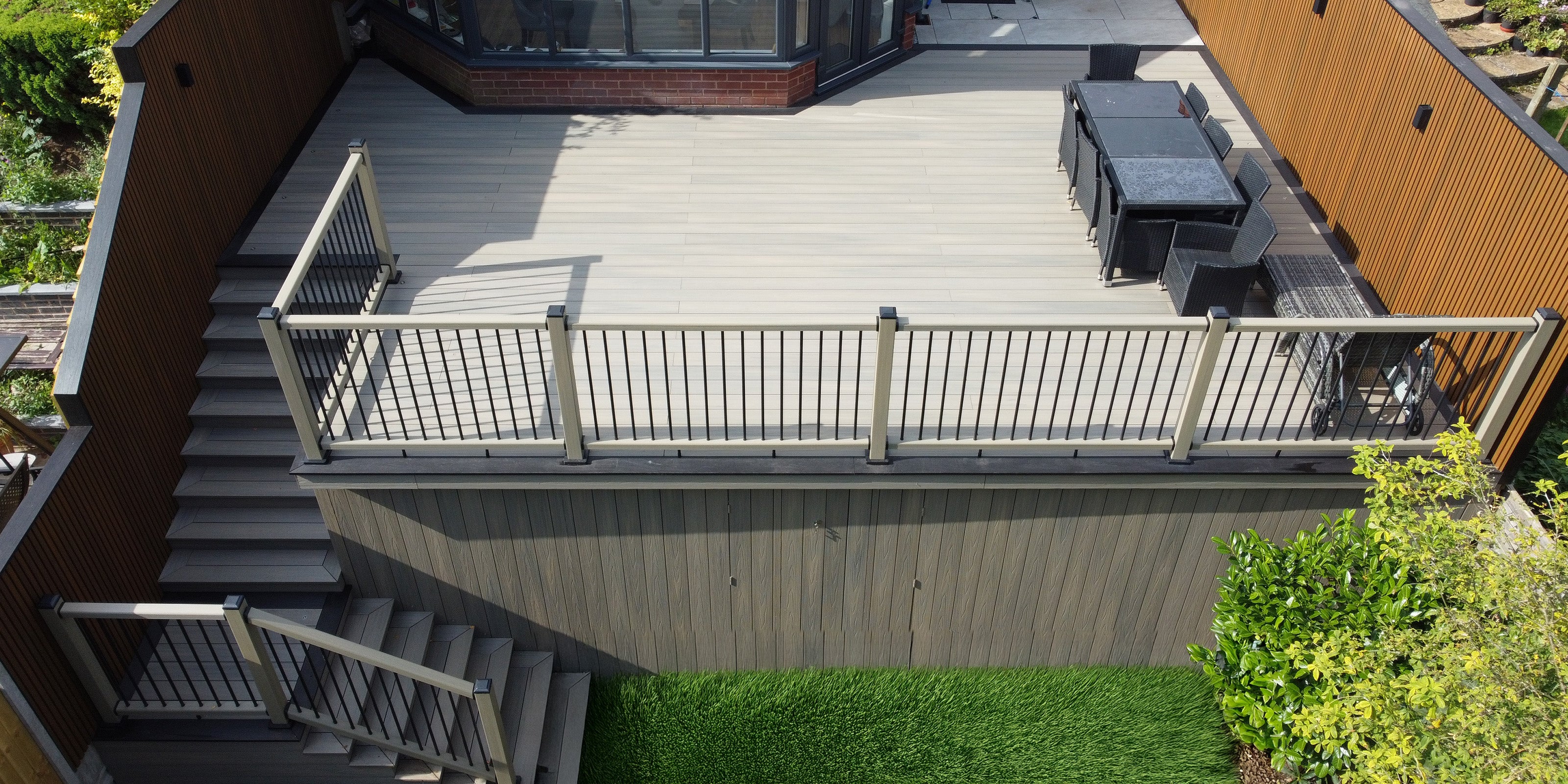 NeoTimber Composite Balustrade Samples - top-down view of a composite deck with balustrade stairs leading down to a grassy area