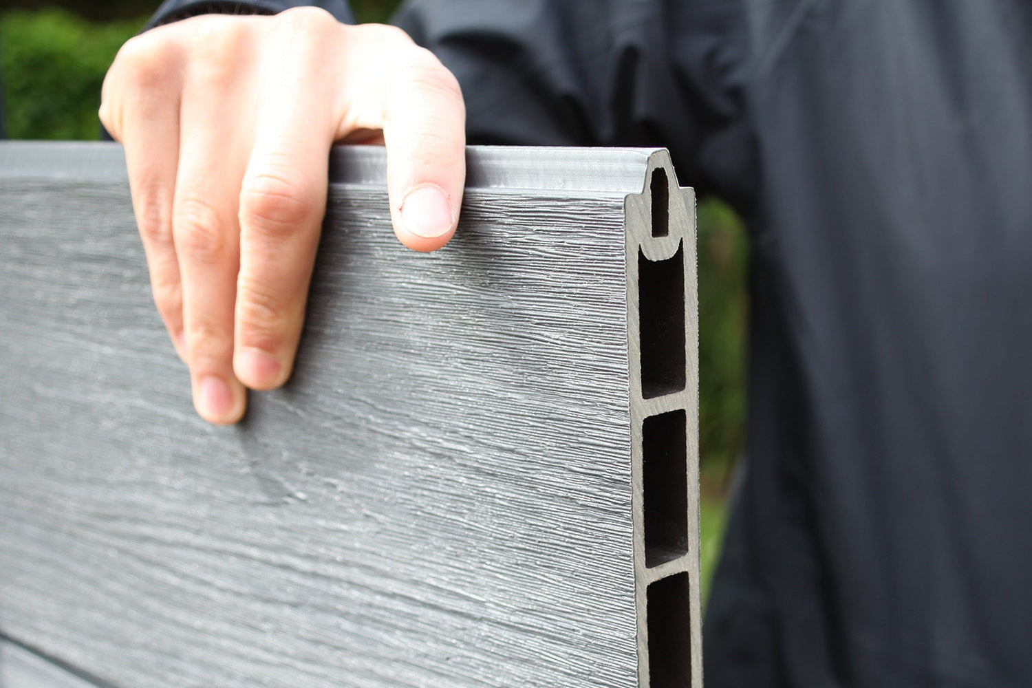 slotting a neotimber composite fence board into place