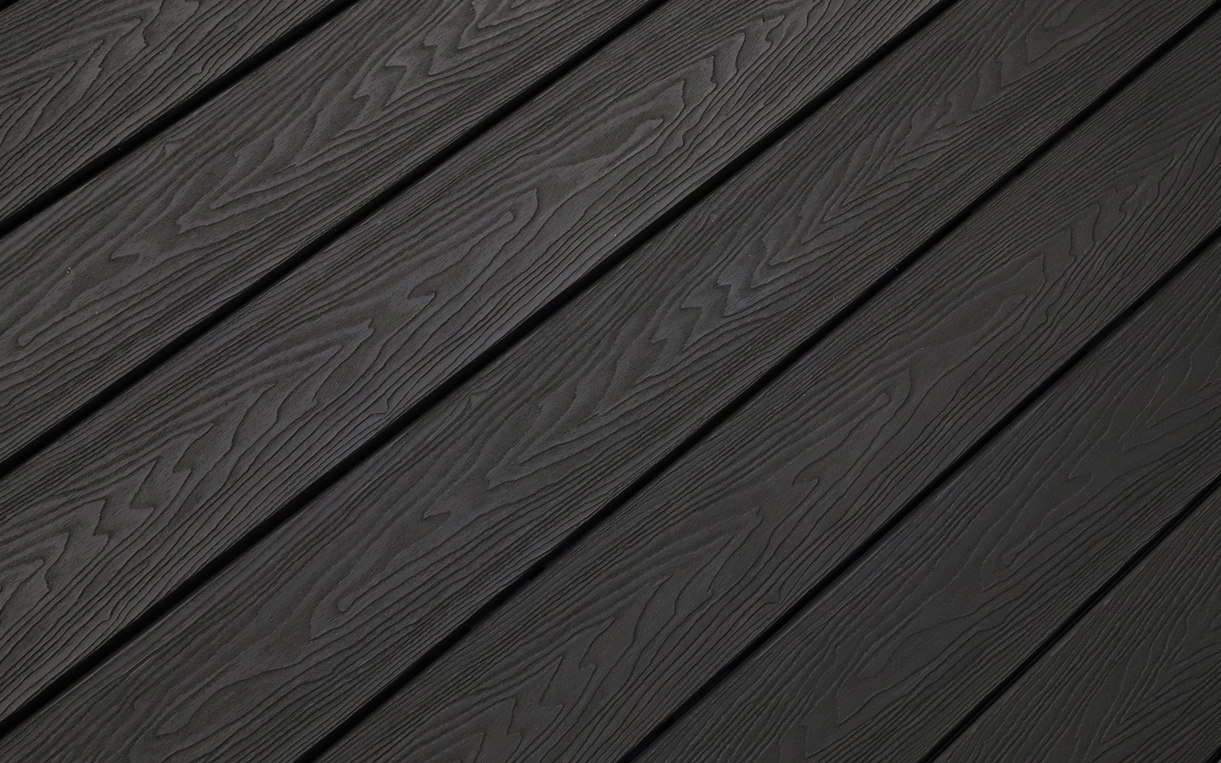 charcoal black composite decking planks with a natural woodgrain pattern