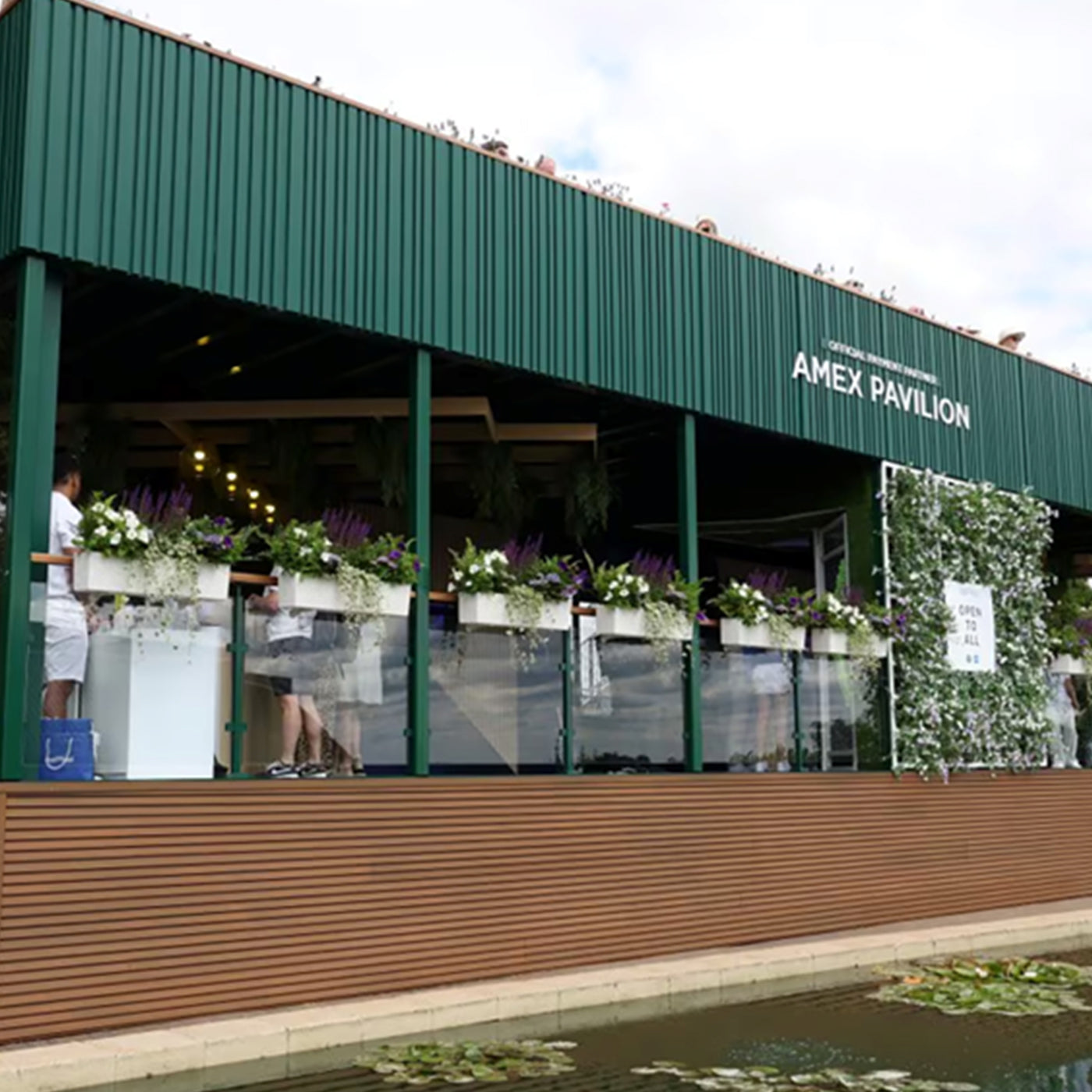 AMEX Pavilion with floral decorations, neotimber cladding and people in the background