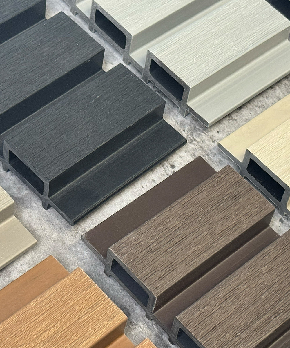 collection of various wood-textured composite cladding trade sample panels in different colours