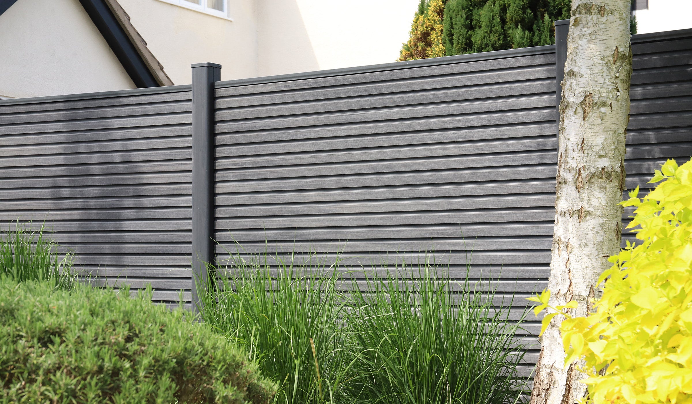 NeoTimber® Composite Fencing in Slatted Design with Landscaping and Planting