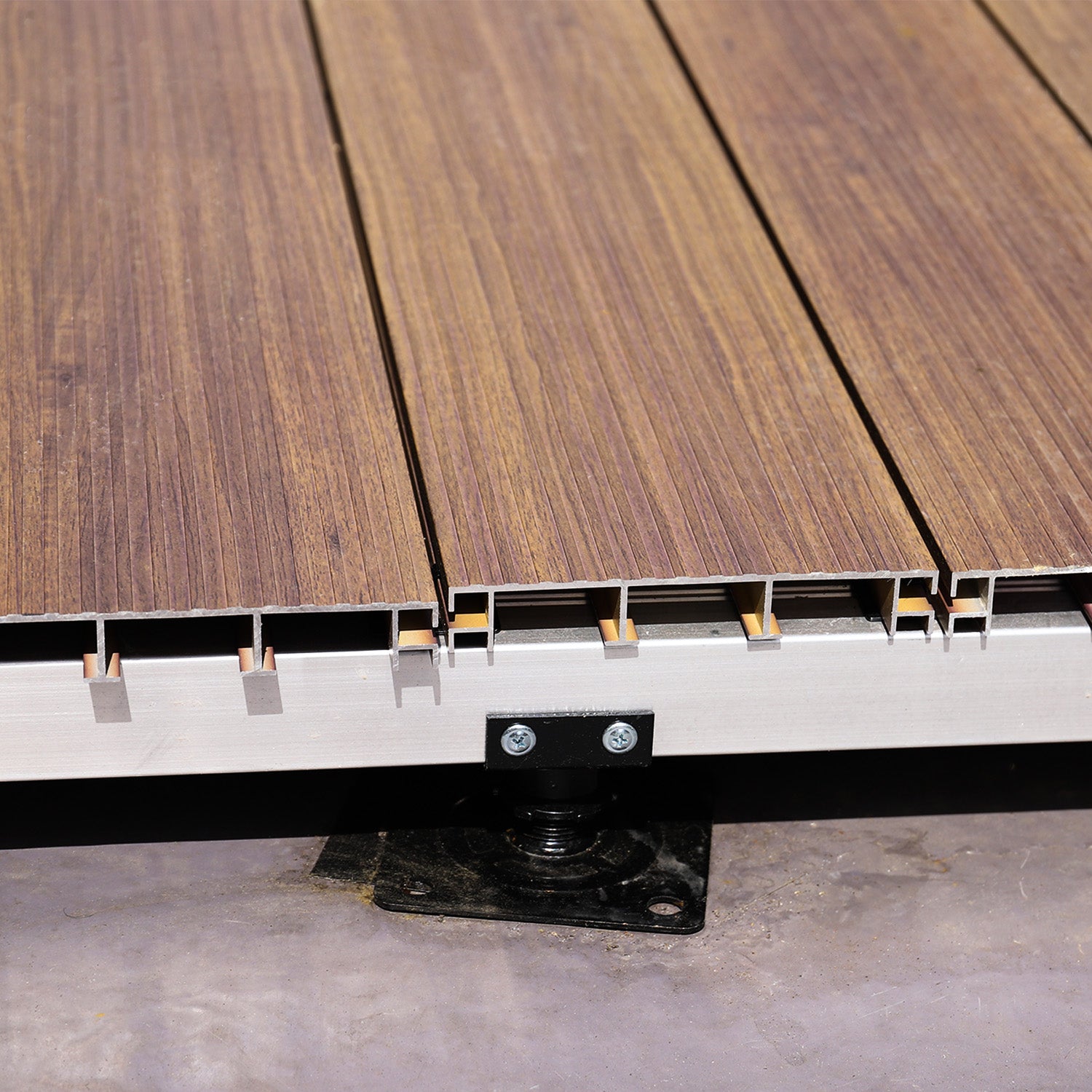 aluminium decking boards secured with metal fixing clips on an aluminium joist subframe