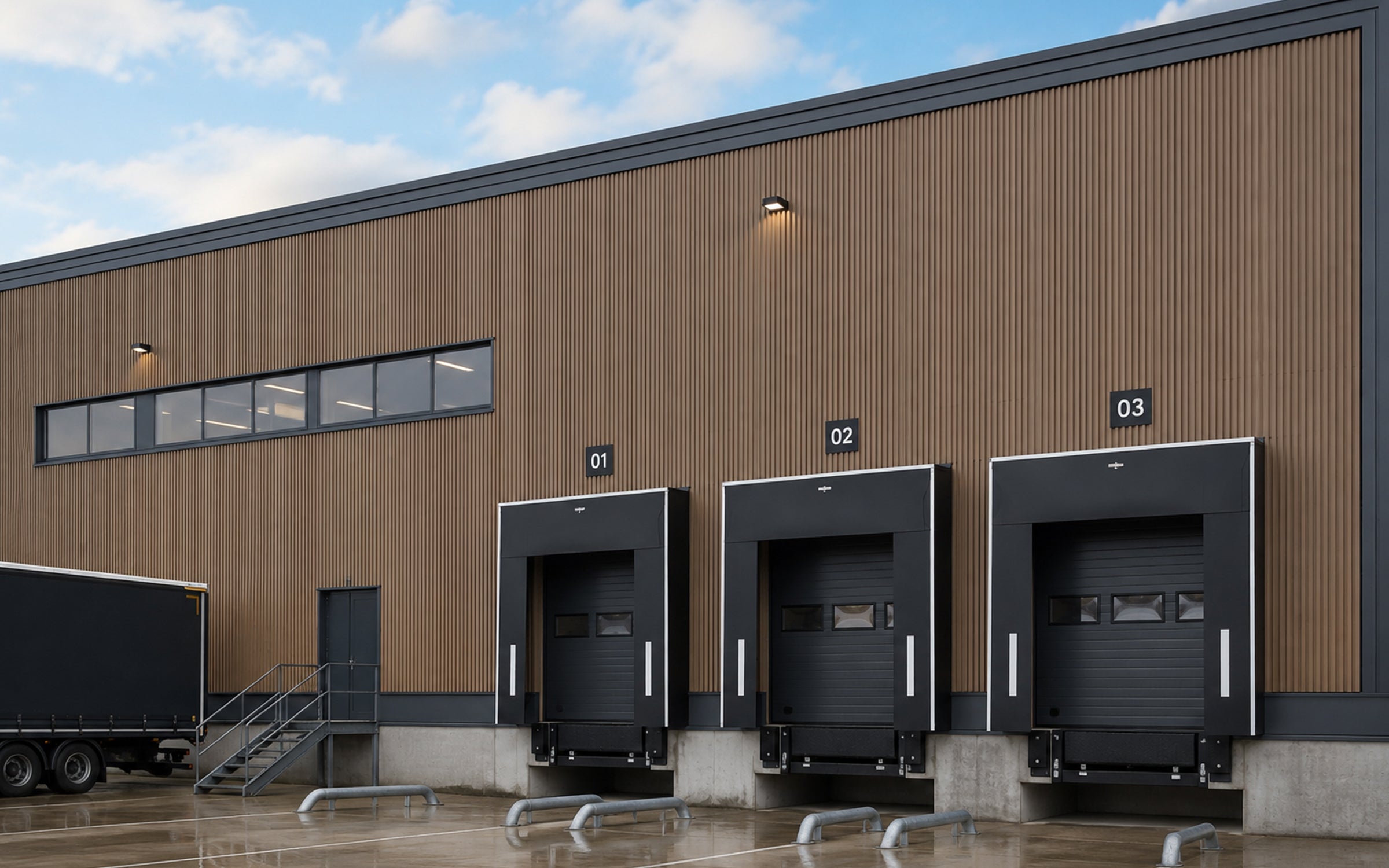 modern warehouse building with three loading docks under a blue sky