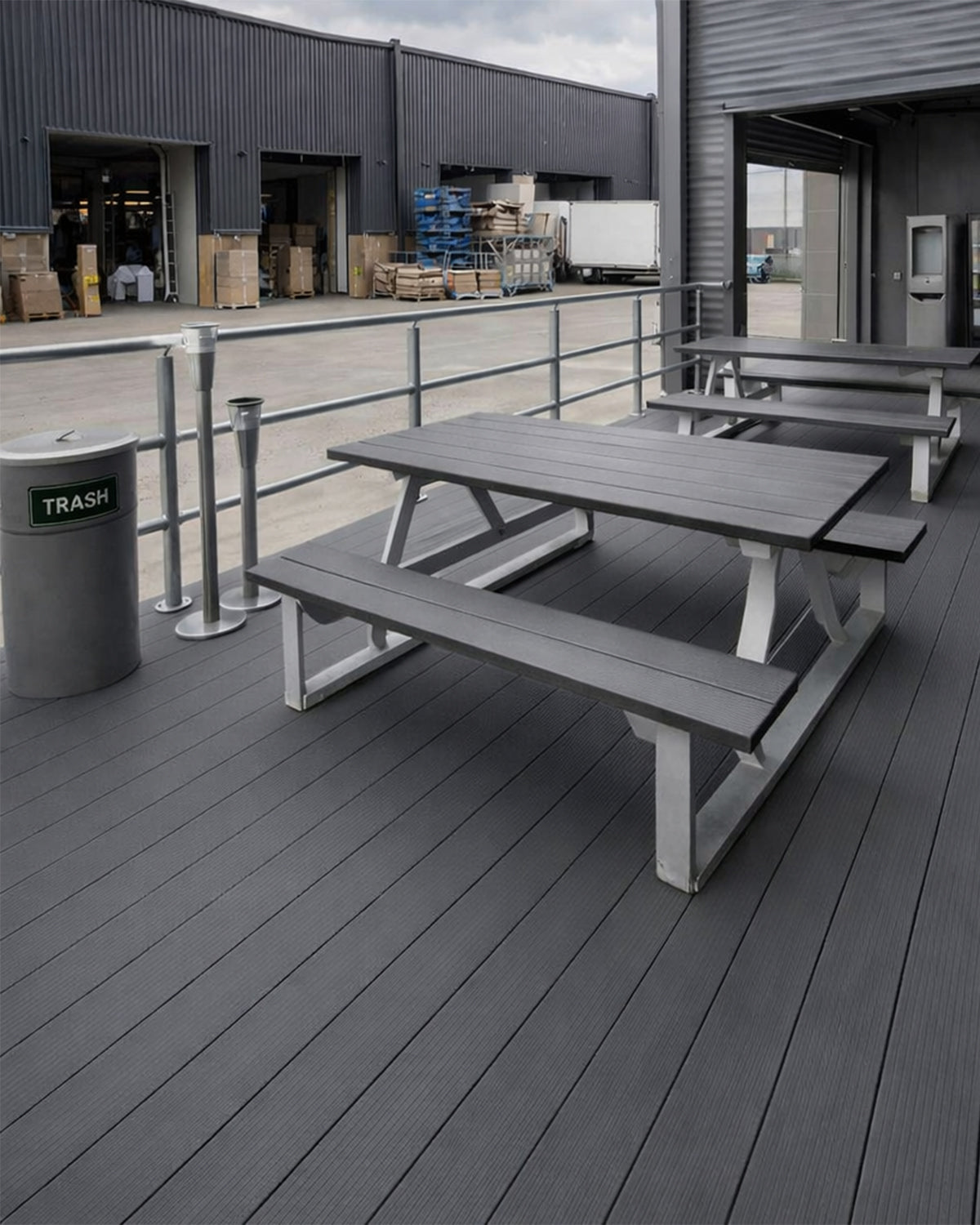 grey composite picnic table on a deck with storage area in the background