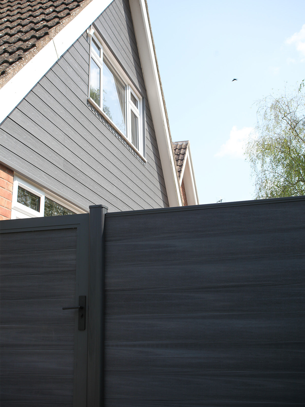 NeoTimber® Deluxe Charcoal Composite Fencing and Deluxe Charcoal Composite Cladding installed together on modern residential property