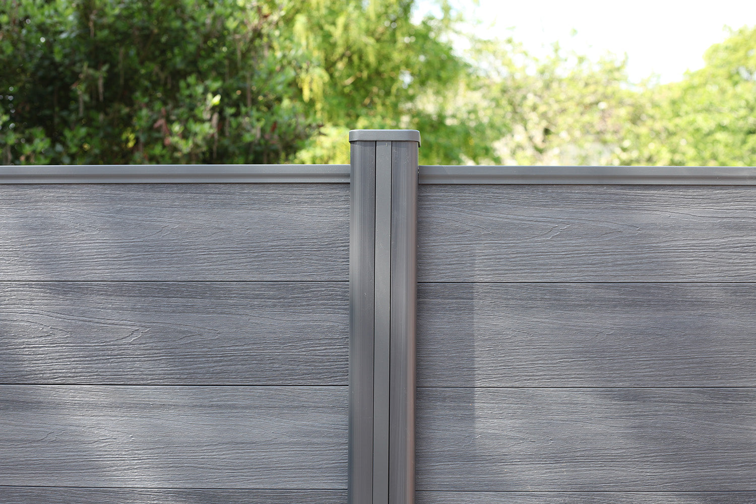 NeoTimber® grey deluxe composite fencing with matching composite fence posts in garden setting