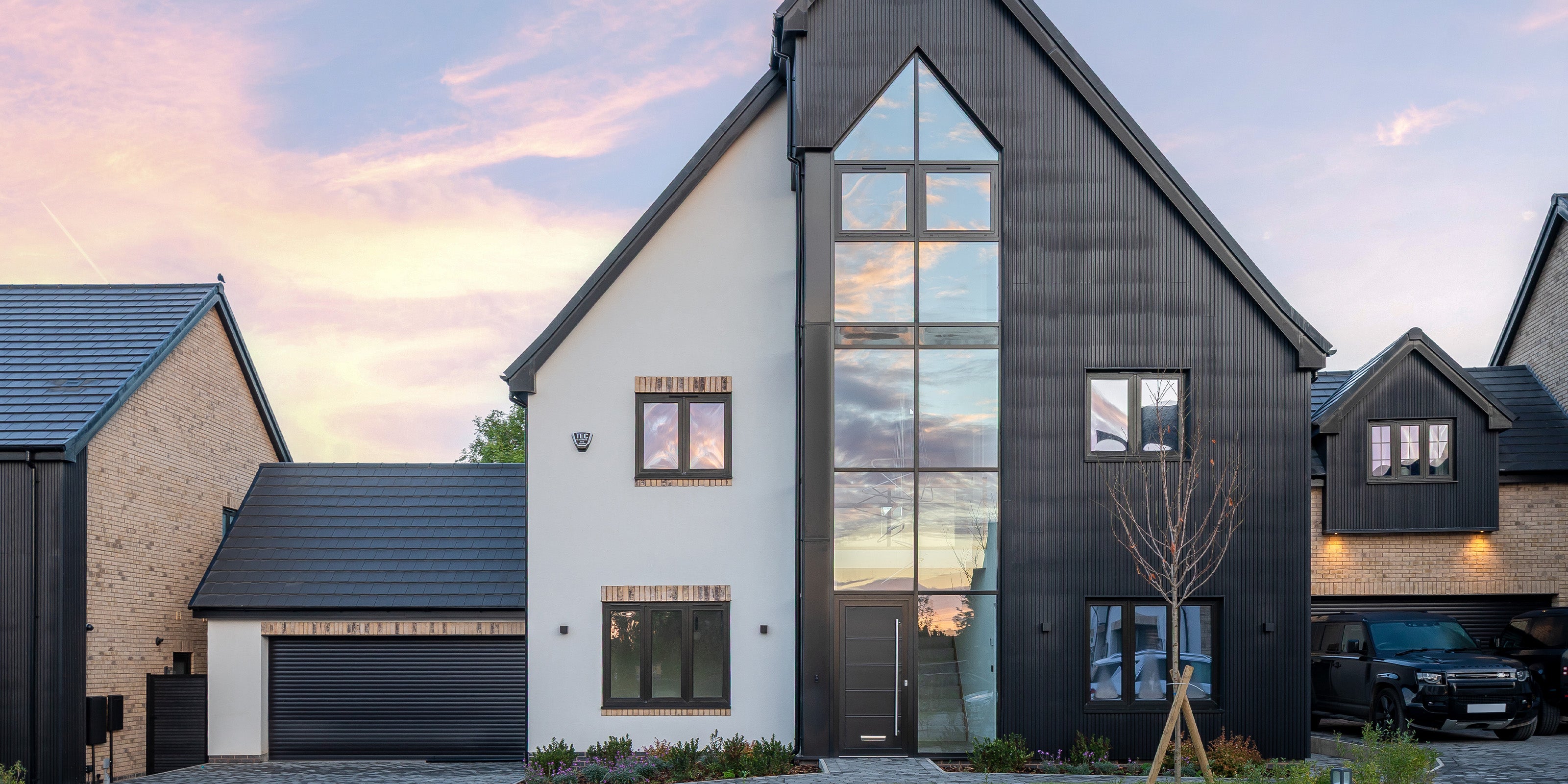 modern house with slatted cladding and large glass windows at sunset