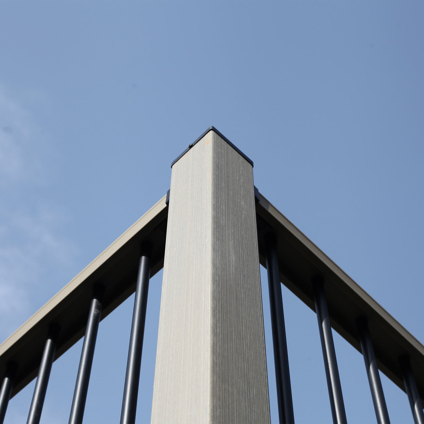 neotimber composite balustrade post with metal spindles against a blue sky