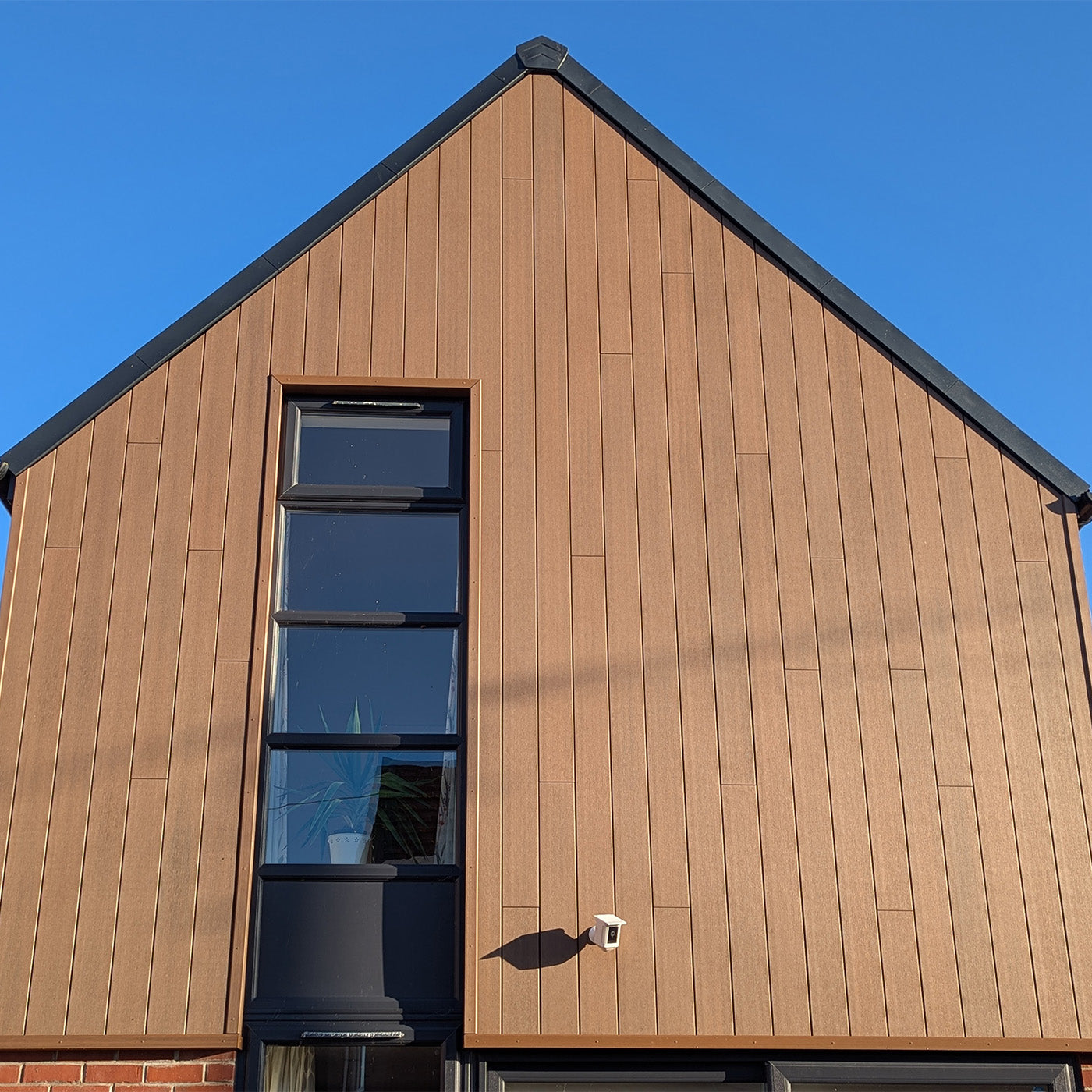 composite cladding house exterior with a clear blue sky - neotimber deluxe teak