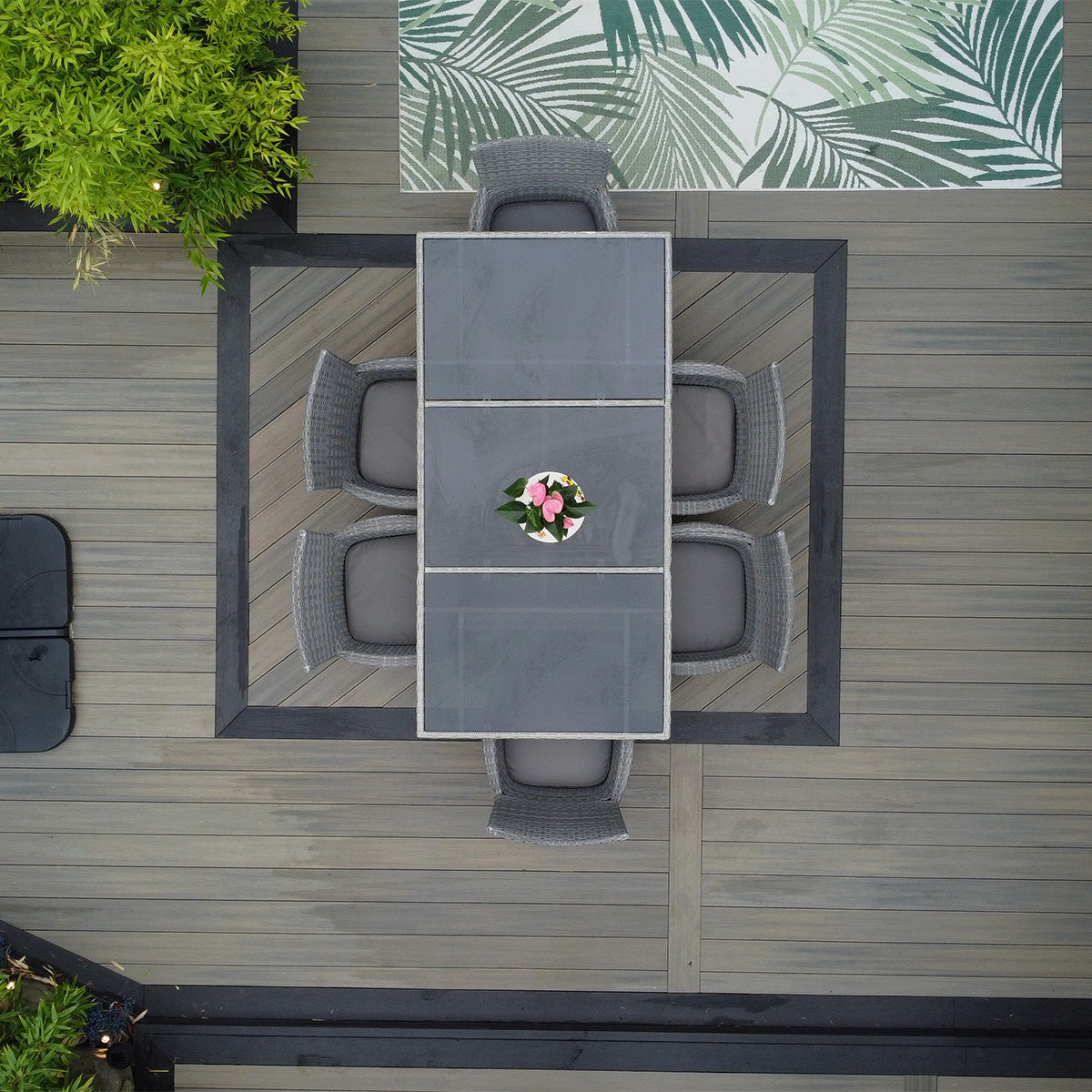 outdoor dining set with table and chairs on a neotimber composite deck