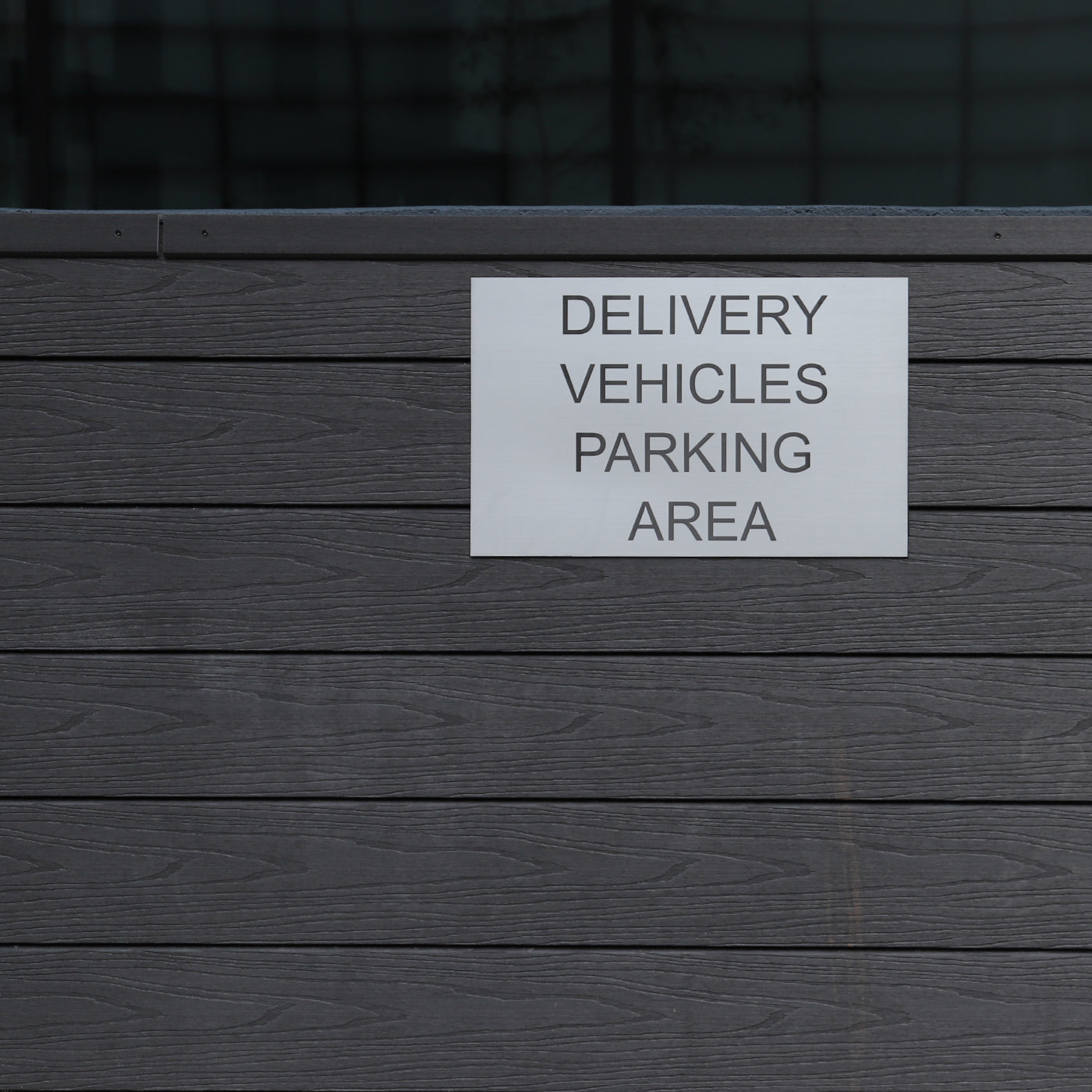 delivery vehicles parking area sign mounted on composite cladding surface
