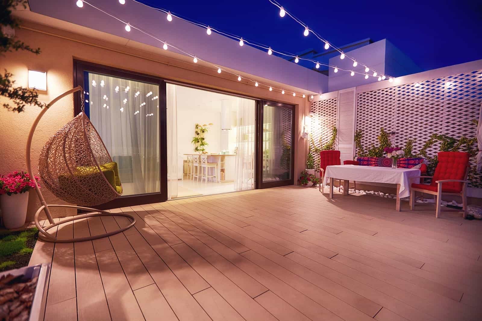 Evening Patio Area With Open Space Kitchen And Sliding Doors low maintenance garden