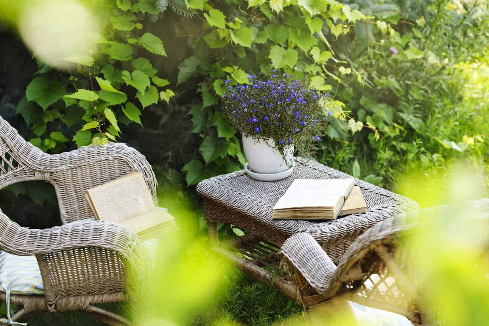 Wicker Table, Chairs And Books In The Garden At Summer Time small garden decking ideas